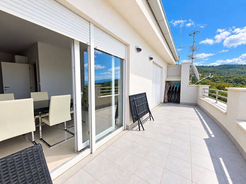 Terrace in front of the living area with view of greenery