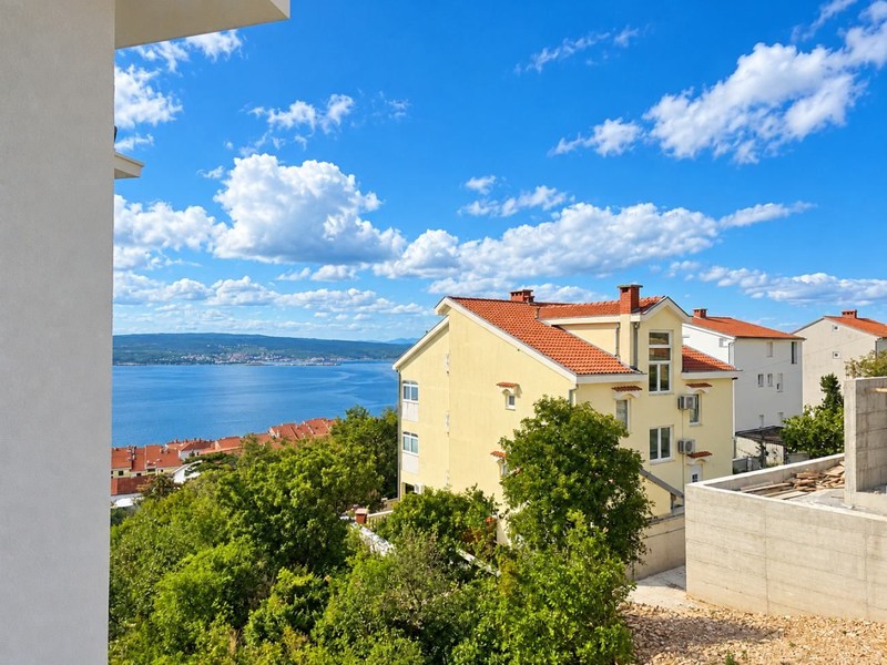 View over the houses to the sea and Krk Island