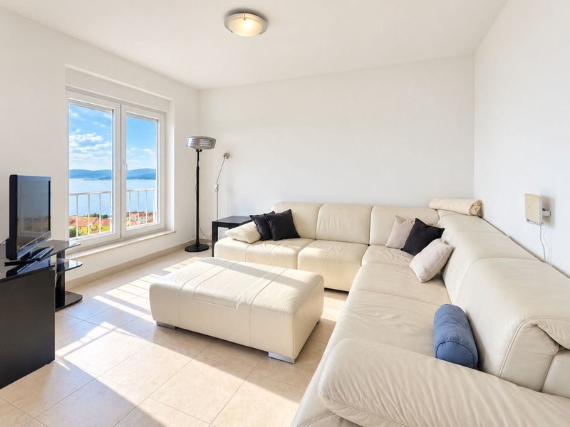 Living room with leather sofa and window to the sea