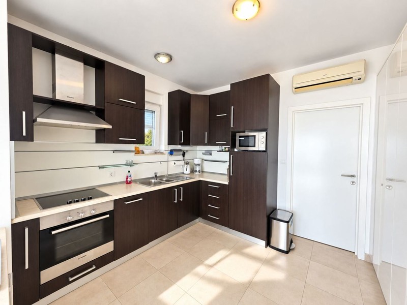 Kitchen with dark units and oven