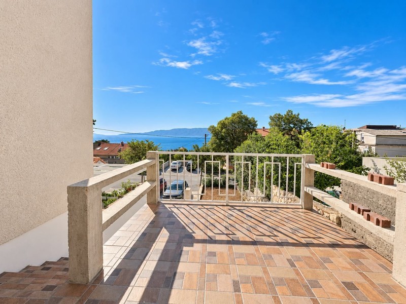 Terrace with railing and view of the sea