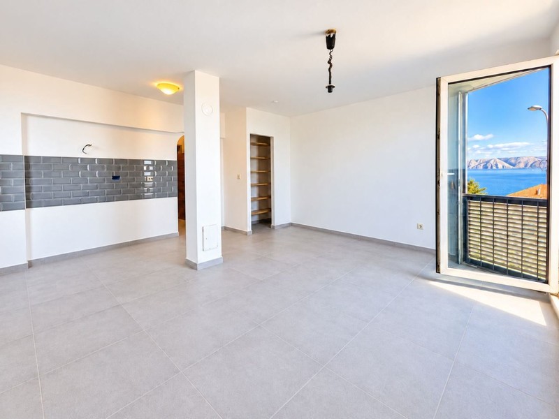 Living area with kitchen wall and shelving