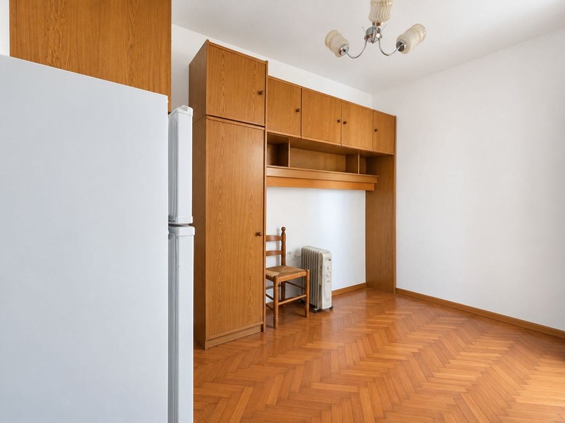 Bedroom with built-in wardrobe and parquet flooring