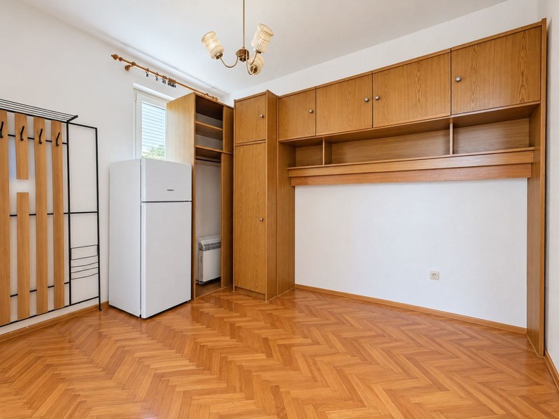 Room with wooden cabinets and refrigerator