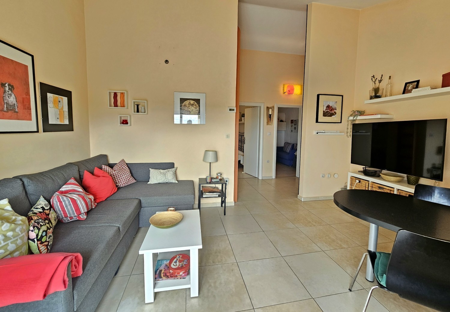 Living area with television and view into the hallway