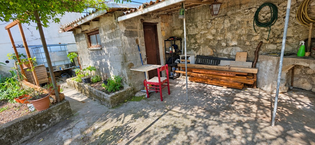 Stone house in the garden with table and chairs