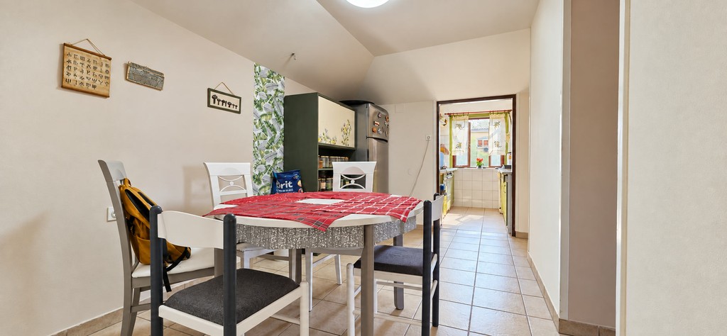 Dining area with table and view into the kitchen