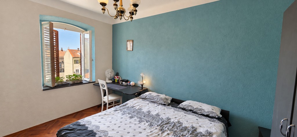 Bedroom with double bed and shutters