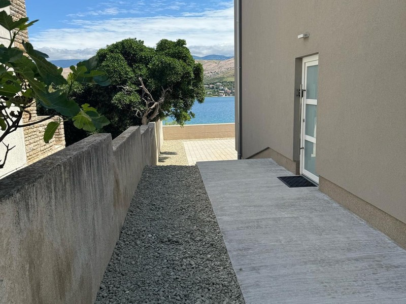Side path along the house with view of the sea