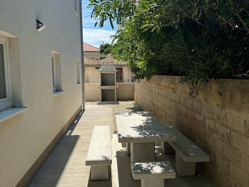 Garden table with benches next to the house