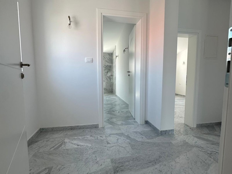 Hallway with access to bathroom and bedroom