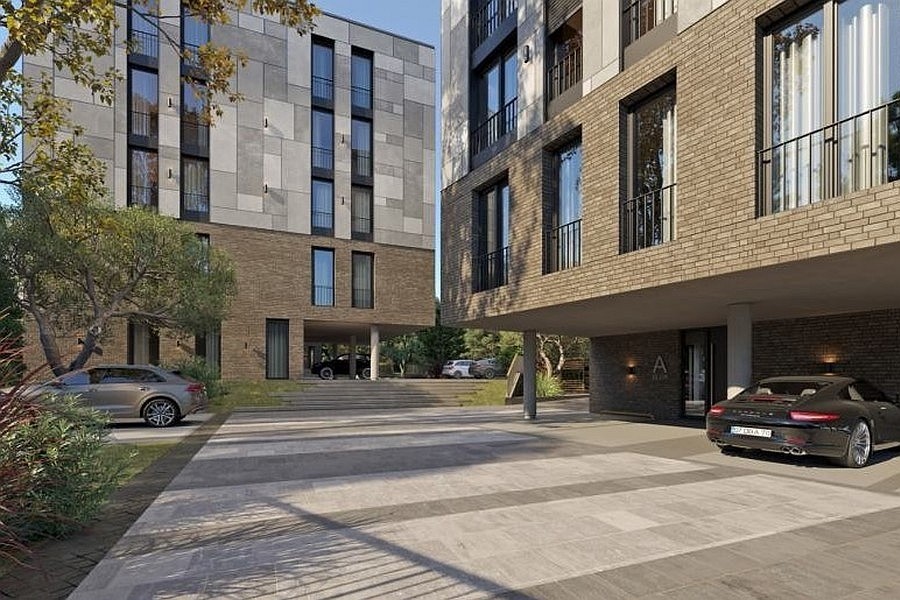 Access road and entrance of the residential complex with parking spaces
