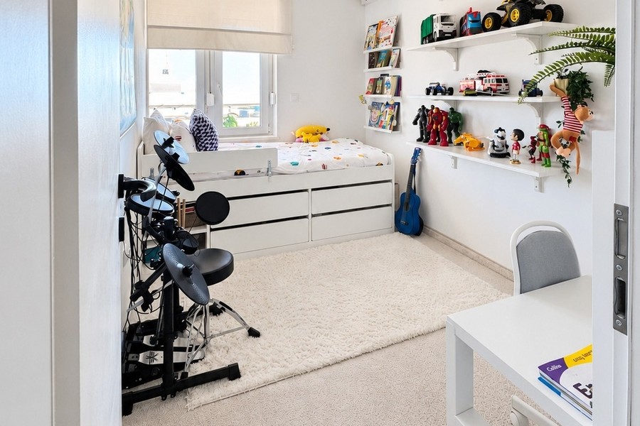 Children's room with bed, shelves and desk