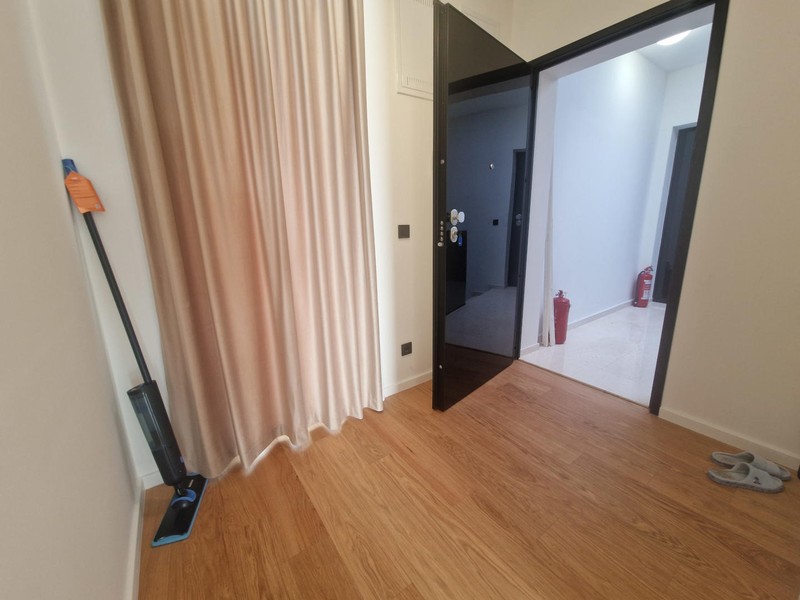 Utility room with washing machine and water heater