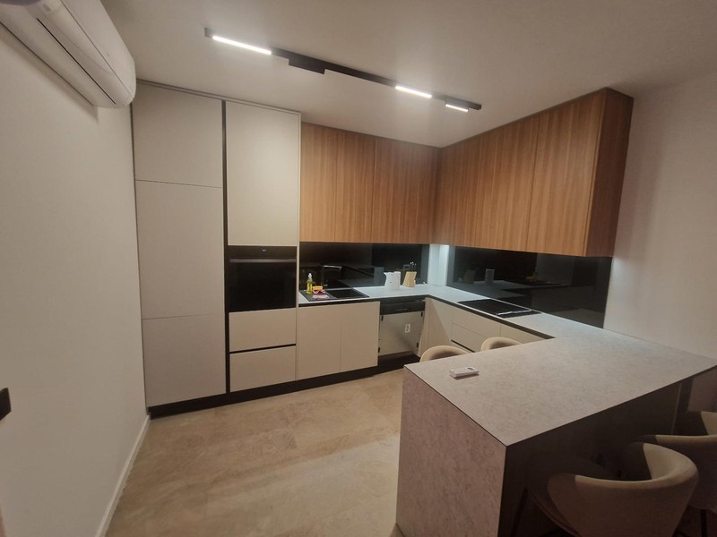 Kitchen with built-in appliances and wooden fronts