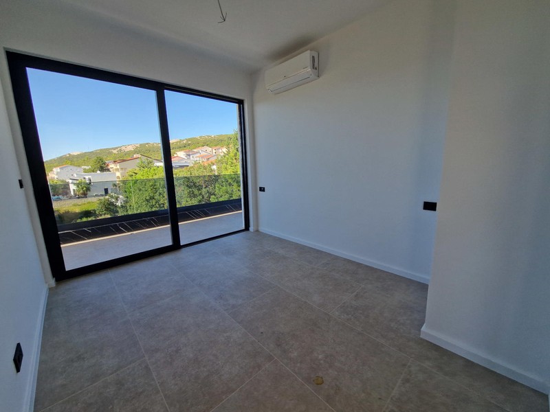 Second bedroom with view of greenery
