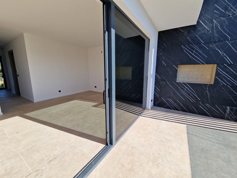 Living area with glass front and marble wall