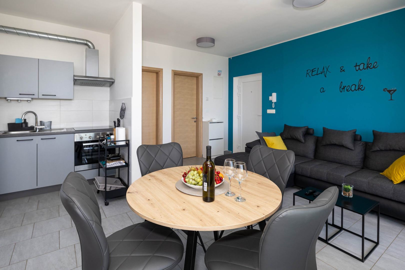 Kitchen living area with corner sofa and round dining table