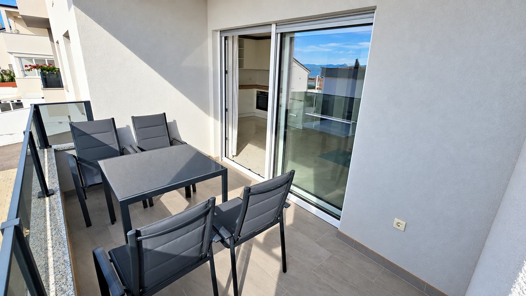 Covered loggia with dining table and sliding door
