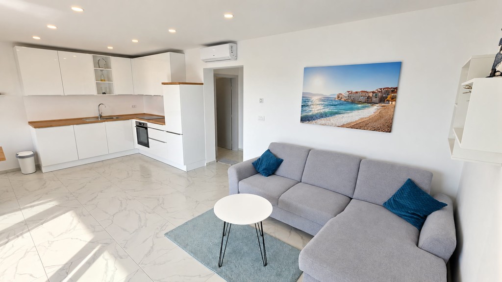 Living room with sofa and open-plan kitchen