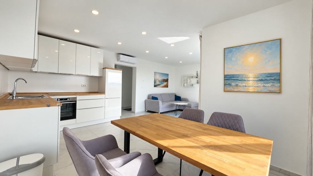 Dining area with wooden table and kitchen