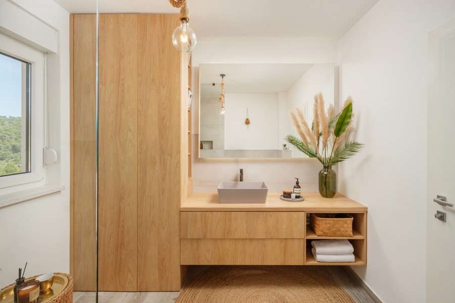 Bathroom with wooden vanity unit and mirror