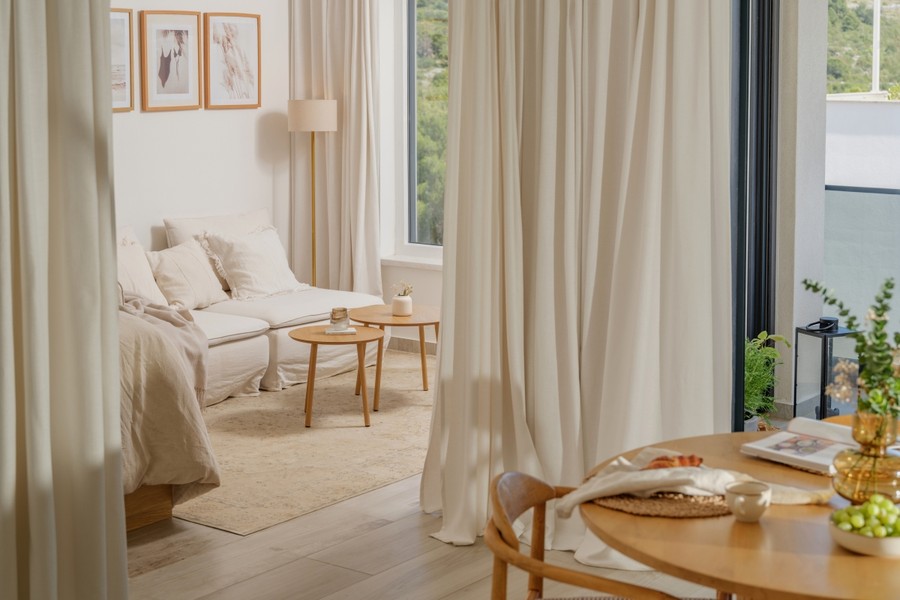 Living area with sofa, curtains and coffee table