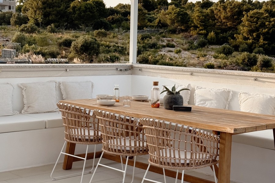 Outdoor seating area with long wooden table