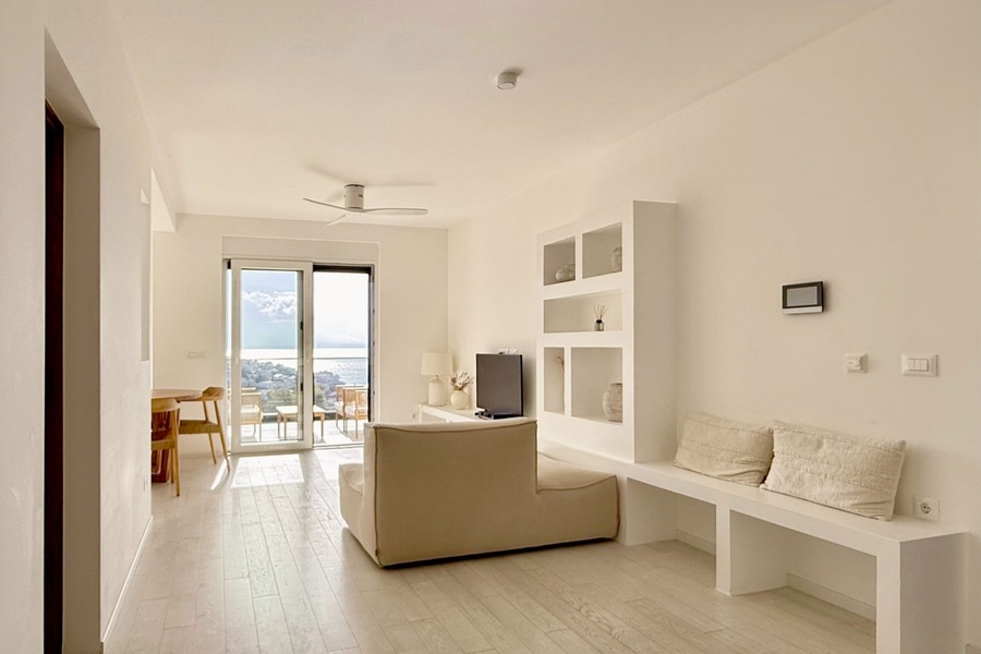 Living room with sofa and view towards the balcony