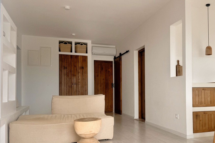 Living area with wooden doors and air conditioning unit