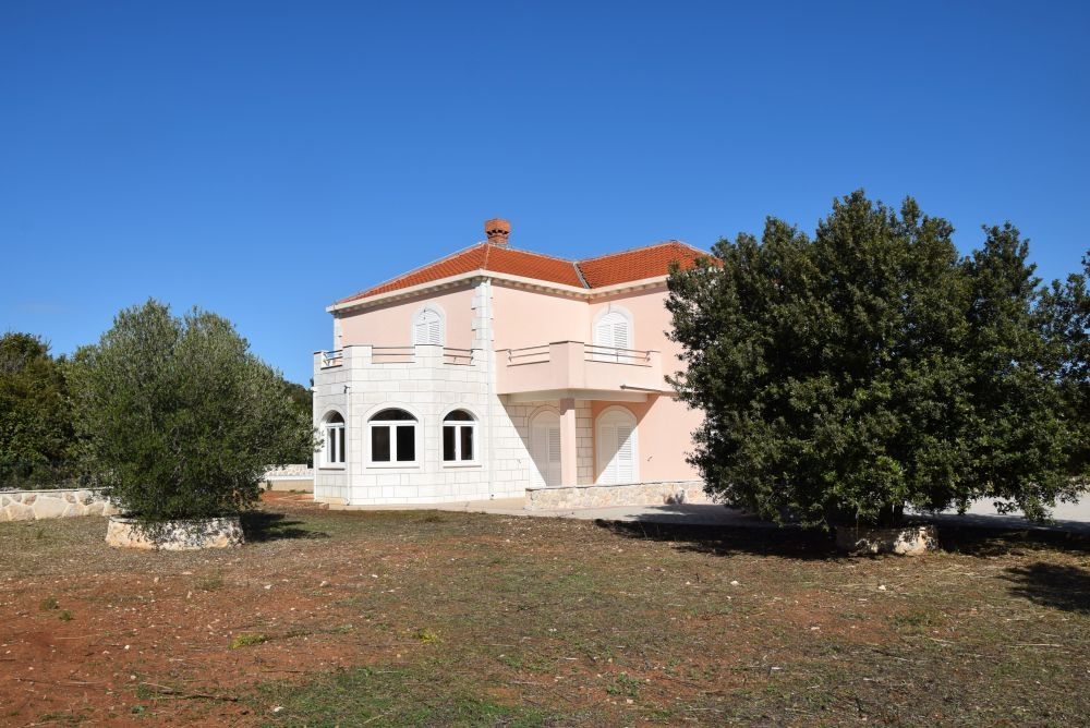 A large garden surrounds the villa.