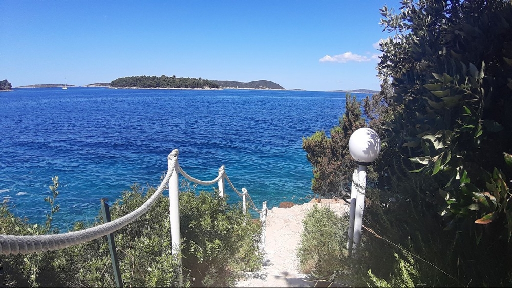 Stairs with rope railings down to the water