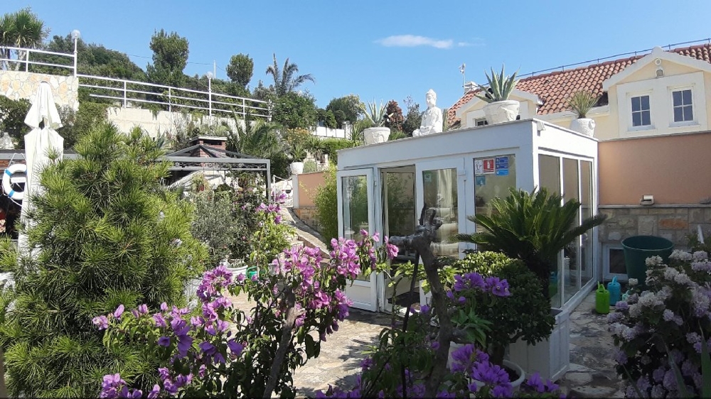 View from the garden of a covered outdoor area of the villa in Central Dalmatia.