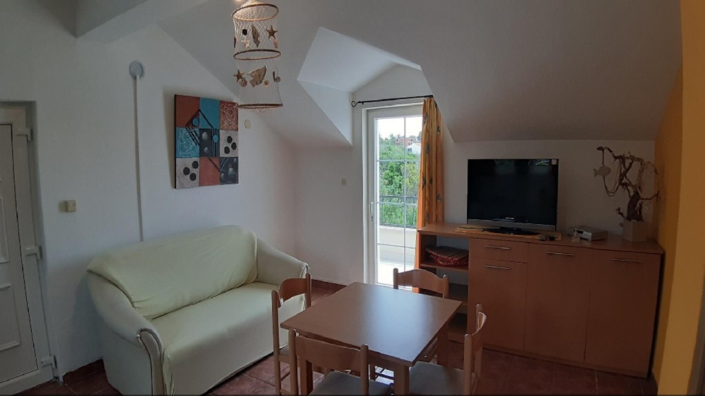 A living room with exit to the balcony of property H1189 on Solta Island.