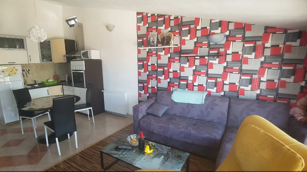 Further living room with seating area and view of the kitchen