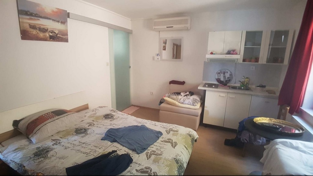 Bedroom with window and cupboards in Croatia