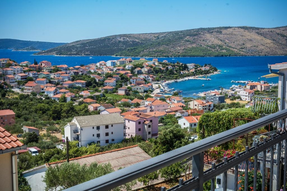 View from the balcony over the village to the harbour and bay