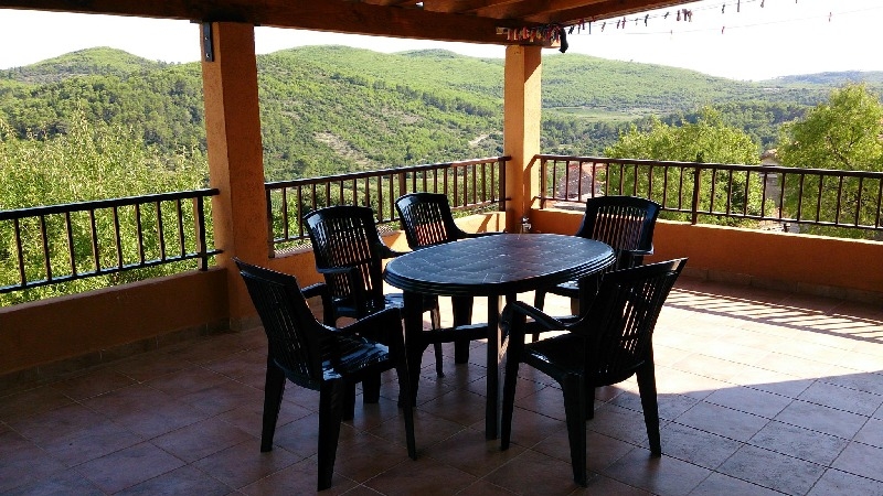 View of the covered balcony with a beautiful view of the idyllic surroundings.