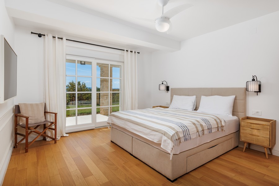 Bedroom with a view of the greenery.