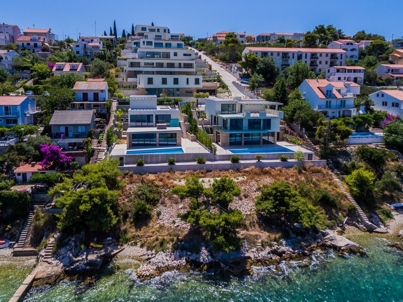 Aerial view of the villas with pools on the rocky coast