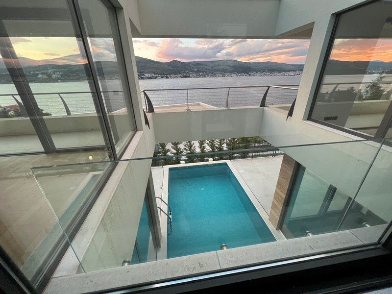 View through the glass balustrade of the pool and the bay