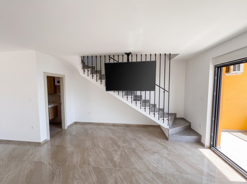 Living room with stairs to the upper floor and access to the bathroom - H2197