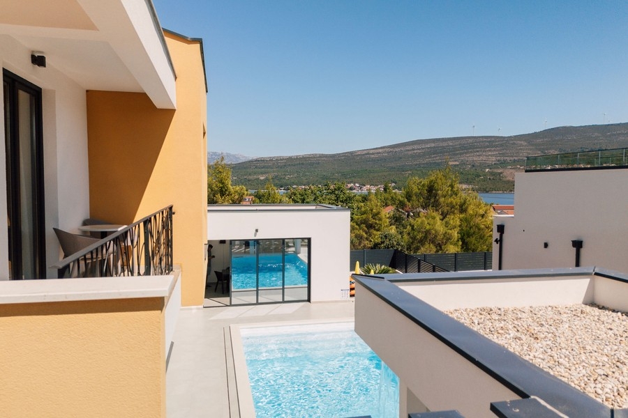 View from the upper floor to the pool and sea