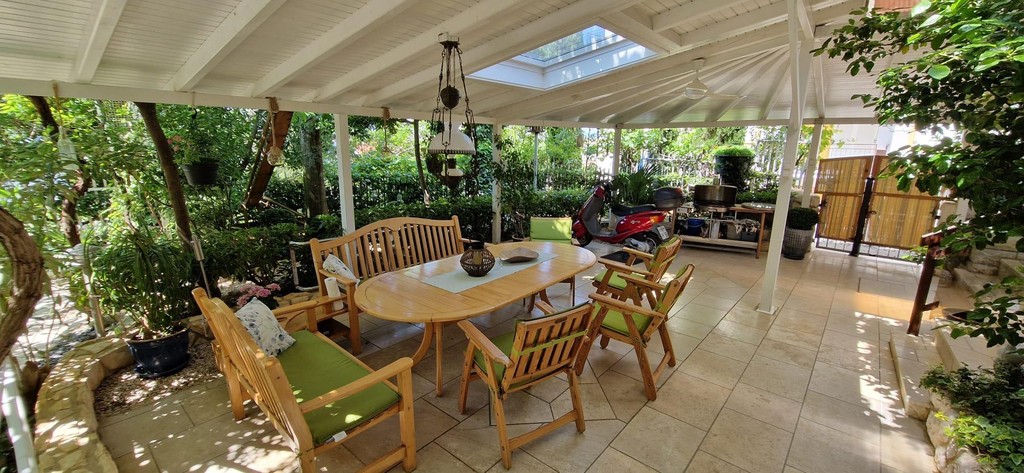 Covered terrace with dining table in the garden