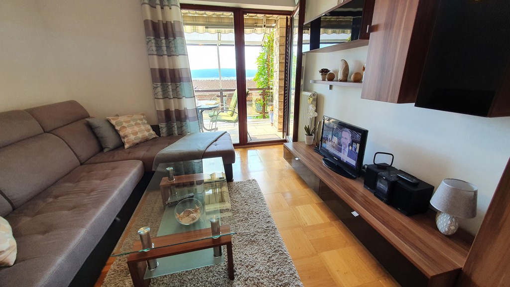 Living area with television and access to the balcony