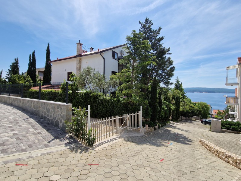 Exterior view of the house with driveway and view towards the sea