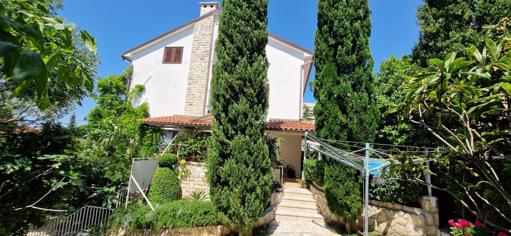 House with cypress trees and garden path