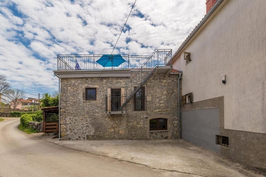 Stone house with an outside staircase to the roof terrace on the lane