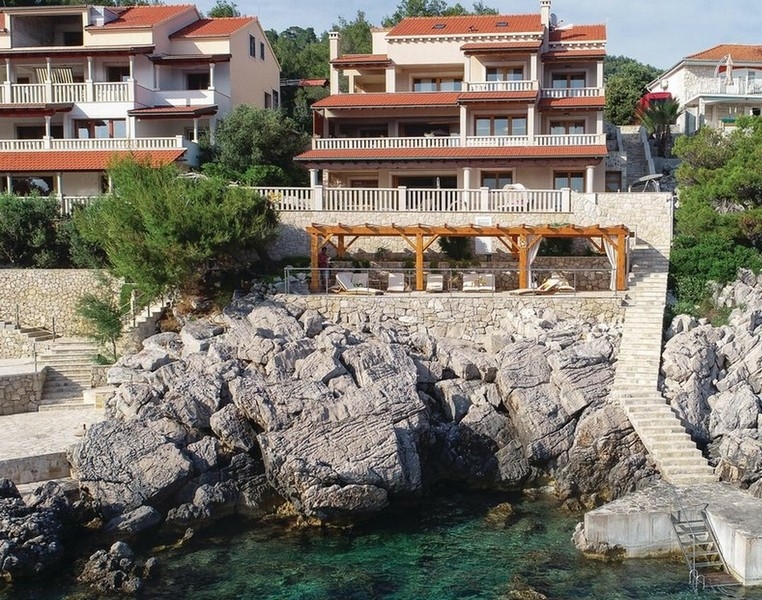 Houses over the rocks with wooden pergola and bathing stairs