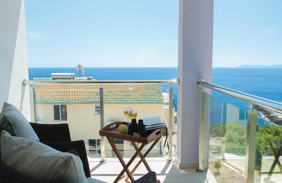Balcony with tray on the folding table and view of the sea